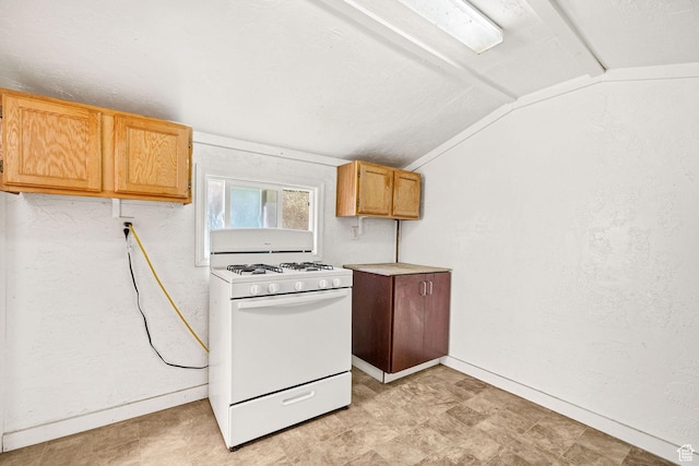 672 E Center St, Providence, UT 84332 - kitchen with gas range gas stove, vaulted ceiling, and light countertops