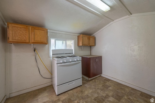 672 E Center St, Providence, UT 84332 - kitchen with gas range gas stove, vaulted ceiling, tile patterned floors, and light countertops