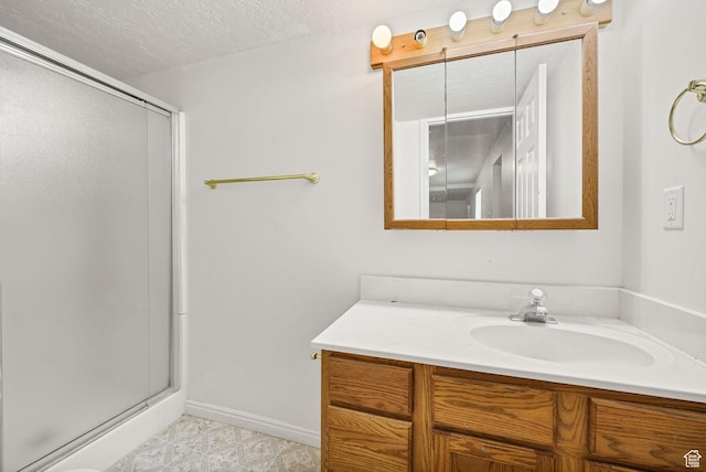 672 E Center St, Providence, UT 84332 - bathroom with vanity, a stall shower, and a textured ceiling