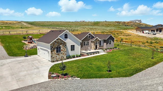 13189 N Brookside Dr, Garland, UT 84312 - view of front of home featuring concrete driveway and stone siding