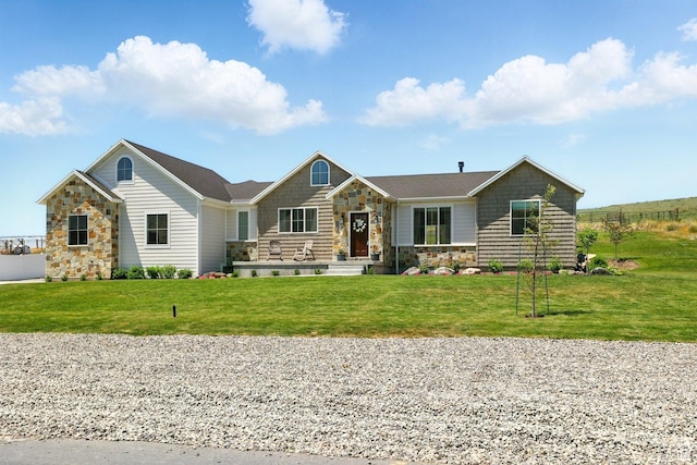 13189 N Brookside Dr, Garland, UT 84312 - view of front of home with stone siding and a front yard