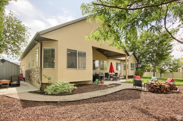 2832 S 1200 W, Syracuse, UT 84075 - back of house with a patio area, stucco siding, and a fire pit