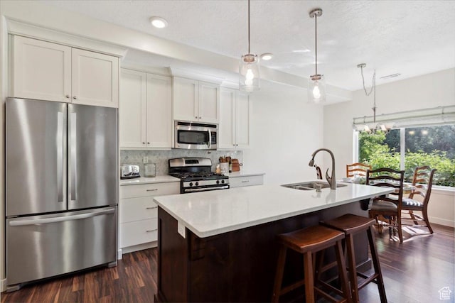 756 Spring Pond Dr, Farmington, UT 84025 - kitchen with stainless steel appliances, dark wood-style floors, tasteful backsplash, light countertops, and white cabinets