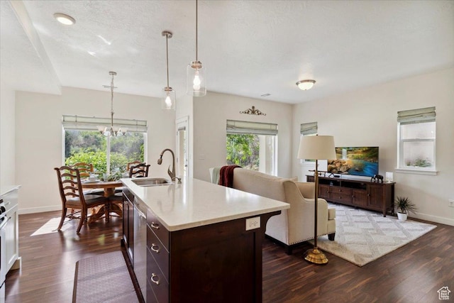 756 Spring Pond Dr, Farmington, UT 84025 - kitchen with dark wood finished floors, a chandelier, light countertops, dark brown cabinetry, and open floor plan