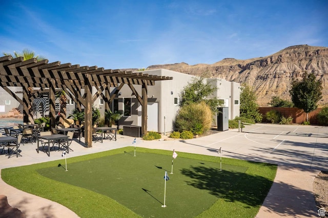 4582 S 1500 W, Hurricane, UT 84737 - view of home's community featuring an area to practice putting, a mountain view, a pergola, and a patio