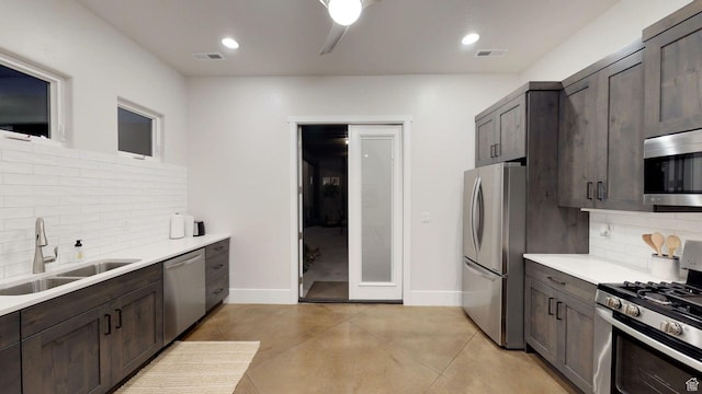 4582 S 1500 W, Hurricane, UT 84737 - kitchen with appliances with stainless steel finishes, backsplash, dark brown cabinetry, light countertops, and recessed lighting