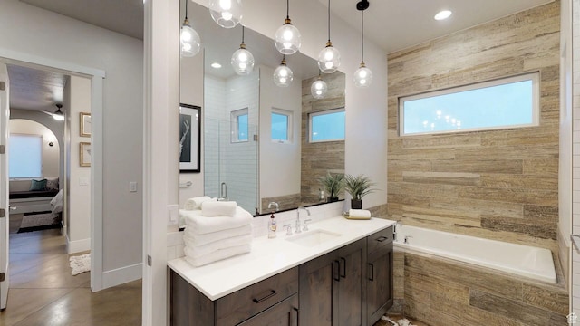 4582 S 1500 W, Hurricane, UT 84737 - bathroom with healthy amount of natural light, vanity, a relaxing tiled tub, and a ceiling fan