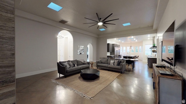 4582 S 1500 W, Hurricane, UT 84737 - living room with arched walkways, ceiling fan, and light tile patterned floors
