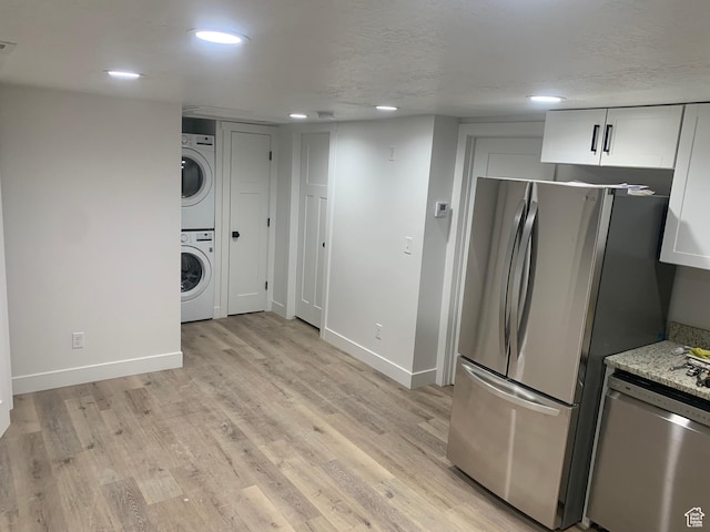 575 40th St, Ogden, UT 84403 - kitchen with stainless steel appliances, estacked washer and dryer, light wood-style flooring, white cabinetry, and recessed lighting