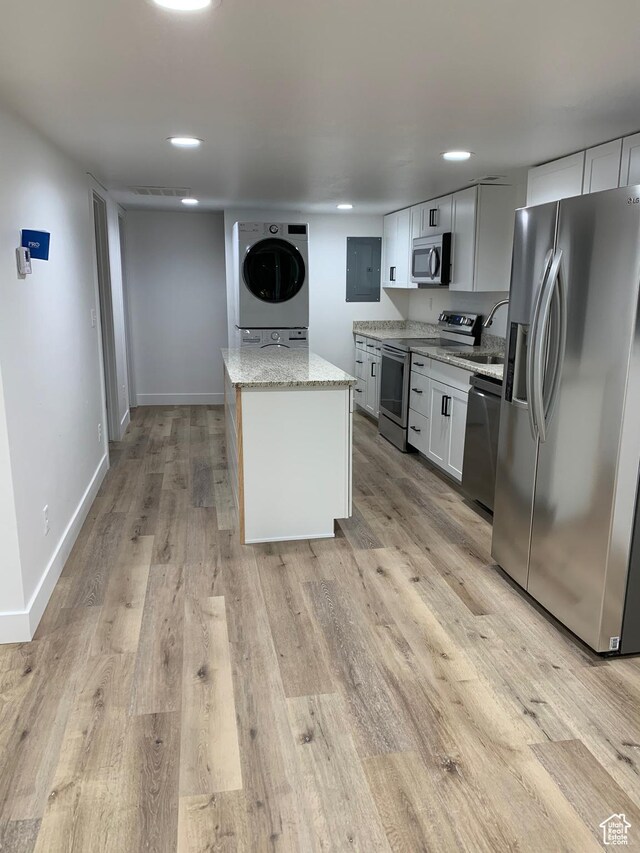 575 40th St, Ogden, UT 84403 - kitchen with stainless steel appliances, light wood-style flooring, light stone countertops, a center island, and recessed lighting