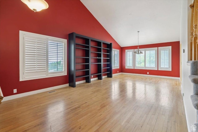 3181 E Deer Creek Cir, Cottonwood Heights, UT 84121 - unfurnished living room with a chandelier, healthy amount of natural light, wood finished floors, and high vaulted ceiling