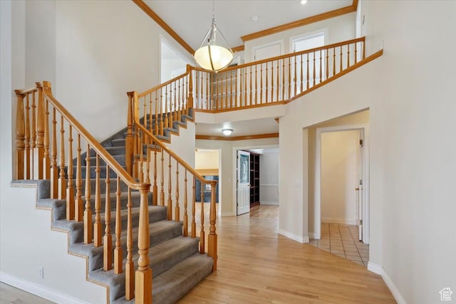 3181 E Deer Creek Cir, Cottonwood Heights, UT 84121 - stairs with wood finished floors, ornamental molding, and a high ceiling