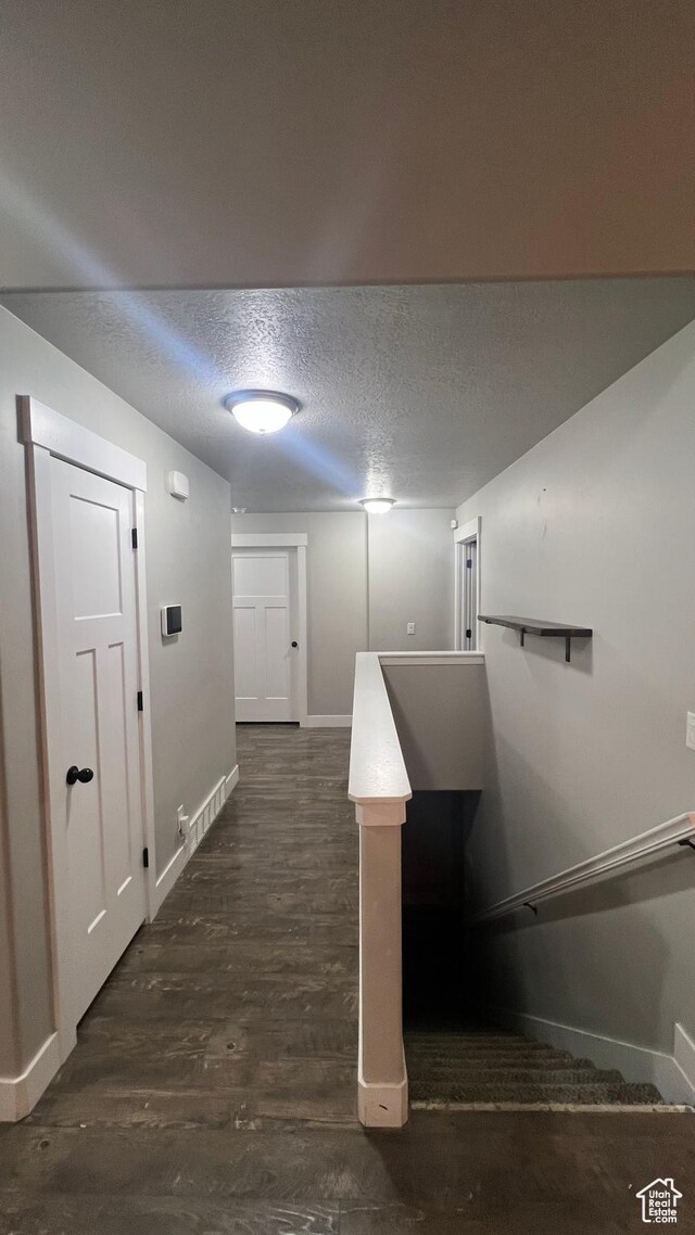 539 S Chan Dr, Grantsville, UT 84029 - corridor with a textured ceiling and dark wood-style flooring