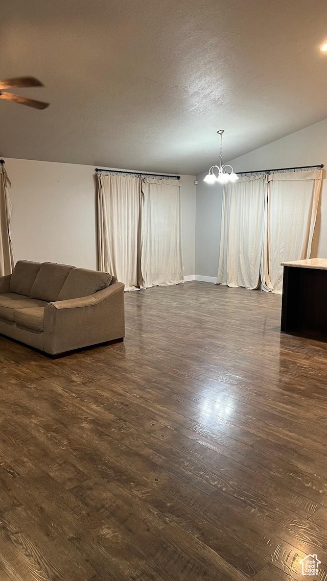 539 S Chan Dr, Grantsville, UT 84029 - unfurnished living room featuring a chandelier, ceiling fan, dark wood finished floors, and lofted ceiling