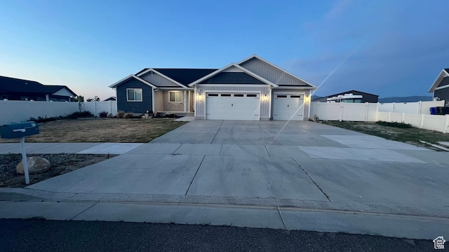 539 S Chan Dr, Grantsville, UT 84029 - view of front facade featuring a garage, driveway, and board and batten siding
