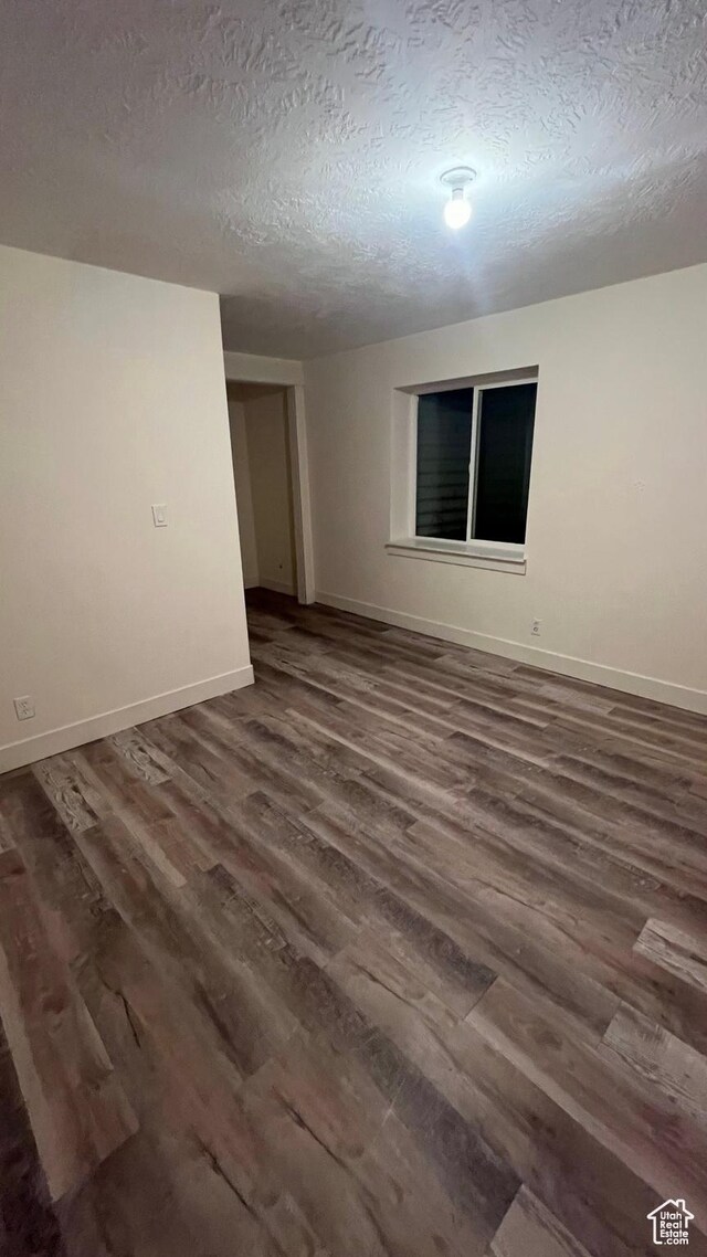 539 S Chan Dr, Grantsville, UT 84029 - unfurnished room with a textured ceiling and dark wood-style floors