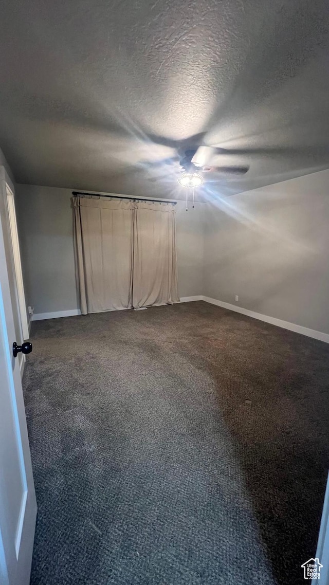 539 S Chan Dr, Grantsville, UT 84029 - unfurnished bedroom with dark colored carpet, a textured ceiling, and ceiling fan