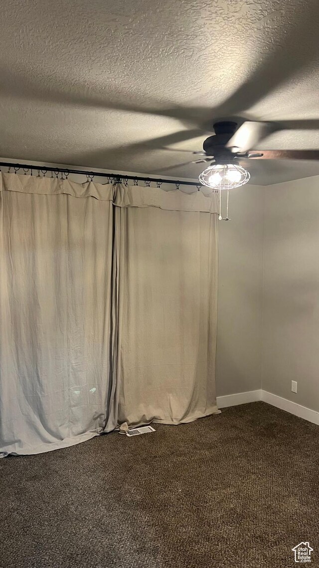 539 S Chan Dr, Grantsville, UT 84029 - spare room featuring ceiling fan, dark carpet, and a textured ceiling