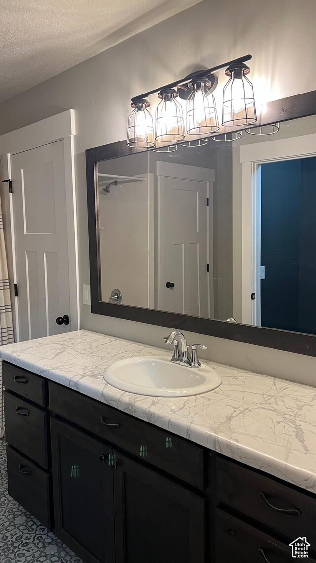 539 S Chan Dr, Grantsville, UT 84029 - bathroom featuring vanity and a textured ceiling