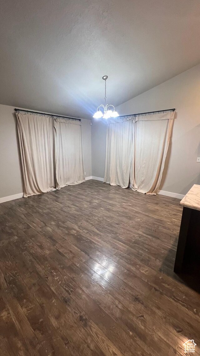 539 S Chan Dr, Grantsville, UT 84029 - unfurnished dining area with dark wood finished floors, a chandelier, and vaulted ceiling