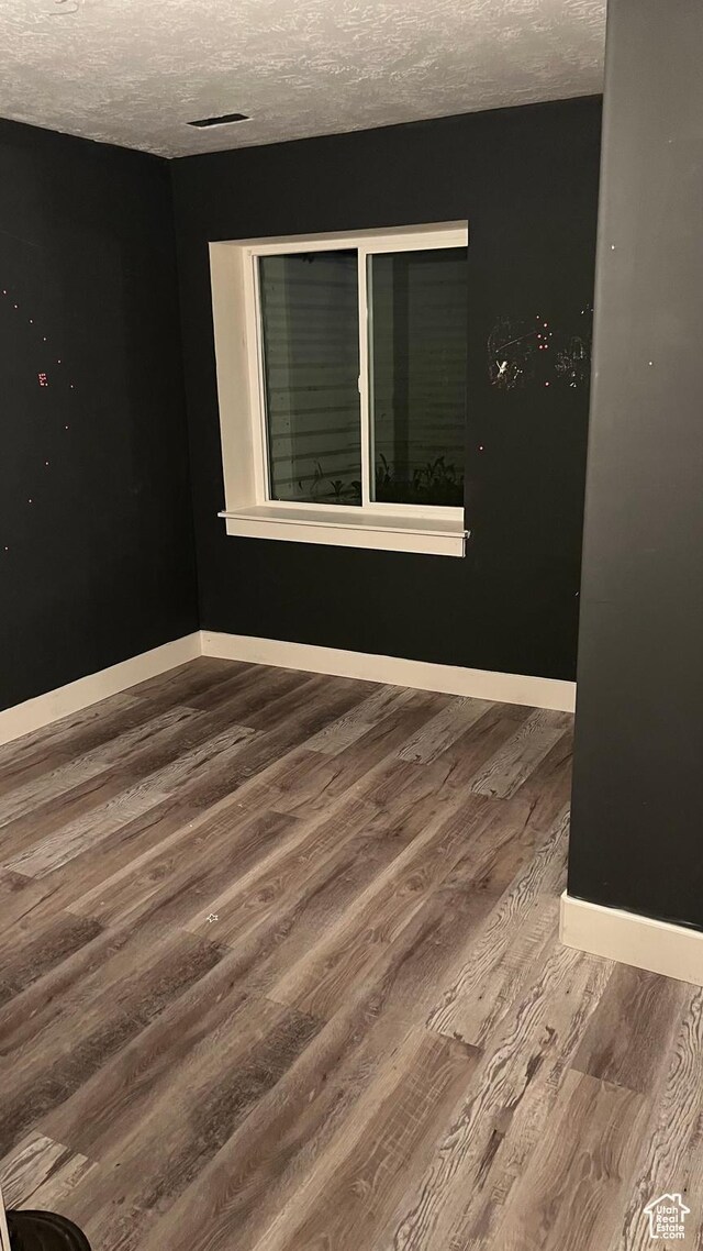 539 S Chan Dr, Grantsville, UT 84029 - spare room featuring wood finished floors and a textured ceiling