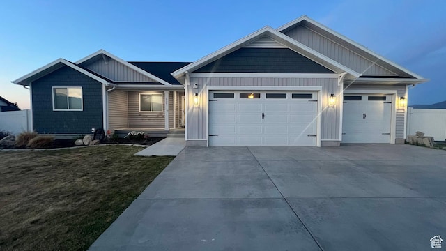 539 S Chan Dr, Grantsville, UT 84029 - view of front facade featuring an attached garage, board and batten siding, concrete driveway, and a front lawn