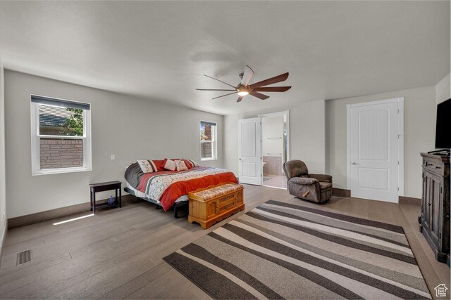 2119 Blair Cir, Santa Clara, UT 84765 - bedroom with multiple windows, wood finished floors, and connected bathroom