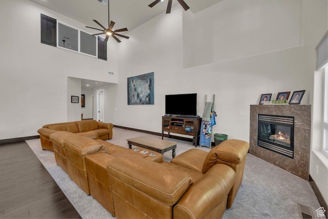 2119 Blair Cir, Santa Clara, UT 84765 - living room with a ceiling fan, a high end fireplace, a towering ceiling, and wood finished floors