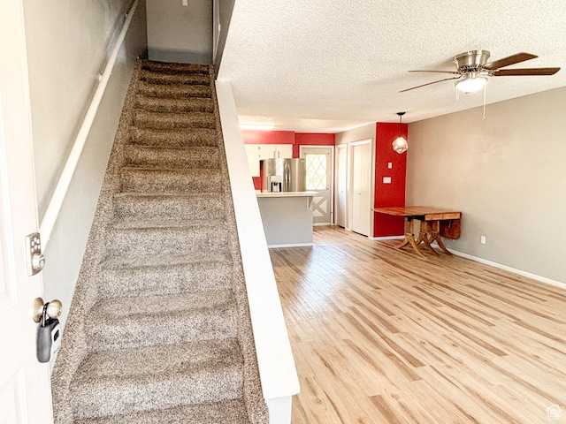 101 N 1850 W Unit 35, Cedar City, UT 84720 - stairs featuring wood finished floors, a ceiling fan, and a textured ceiling