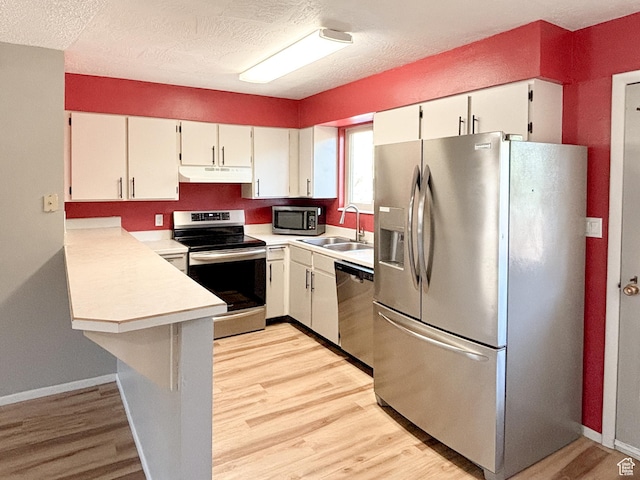 101 N 1850 W Unit 35, Cedar City, UT 84720 - kitchen with stainless steel appliances, under cabinet range hood, light countertops, light wood finished floors, and a textured ceiling