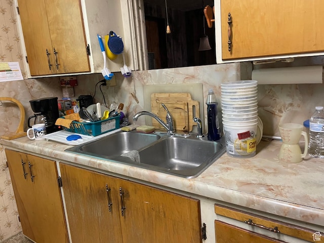 260 W 500 S, Price, UT 84501 - kitchen featuring light countertops, wallpapered walls, and brown cabinetry