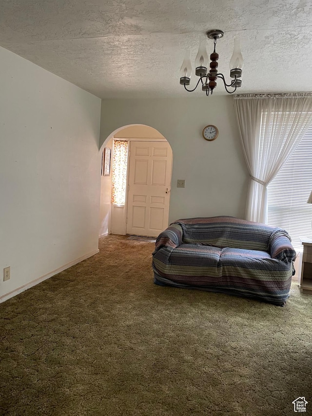 260 W 500 S, Price, UT 84501 - carpeted living area with arched walkways, a chandelier, and a textured ceiling