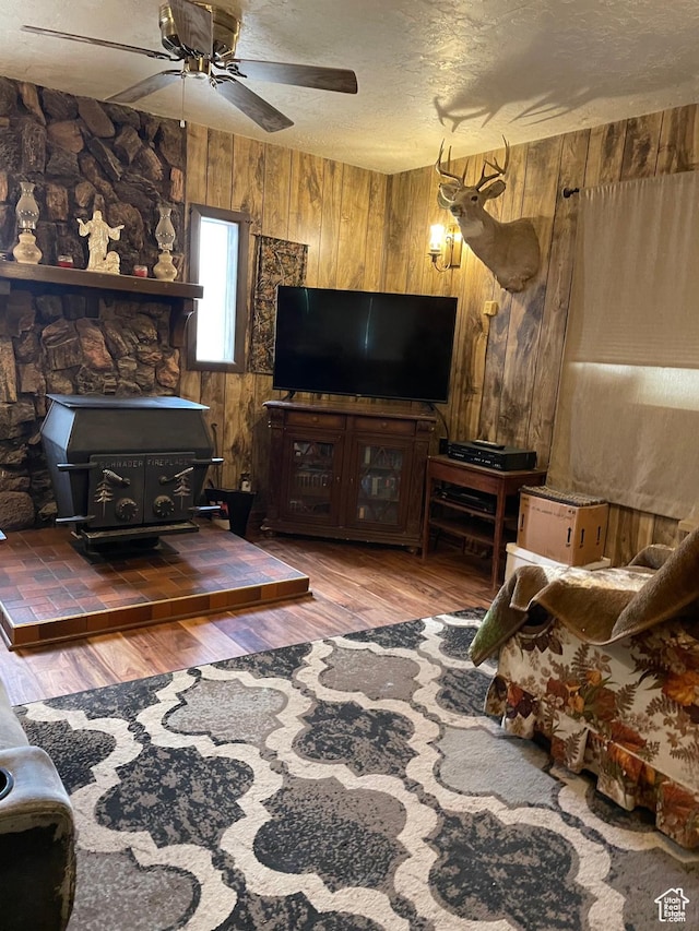 260 W 500 S, Price, UT 84501 - living room with a wood stove, wooden walls, wood finished floors, ceiling fan, and a textured ceiling