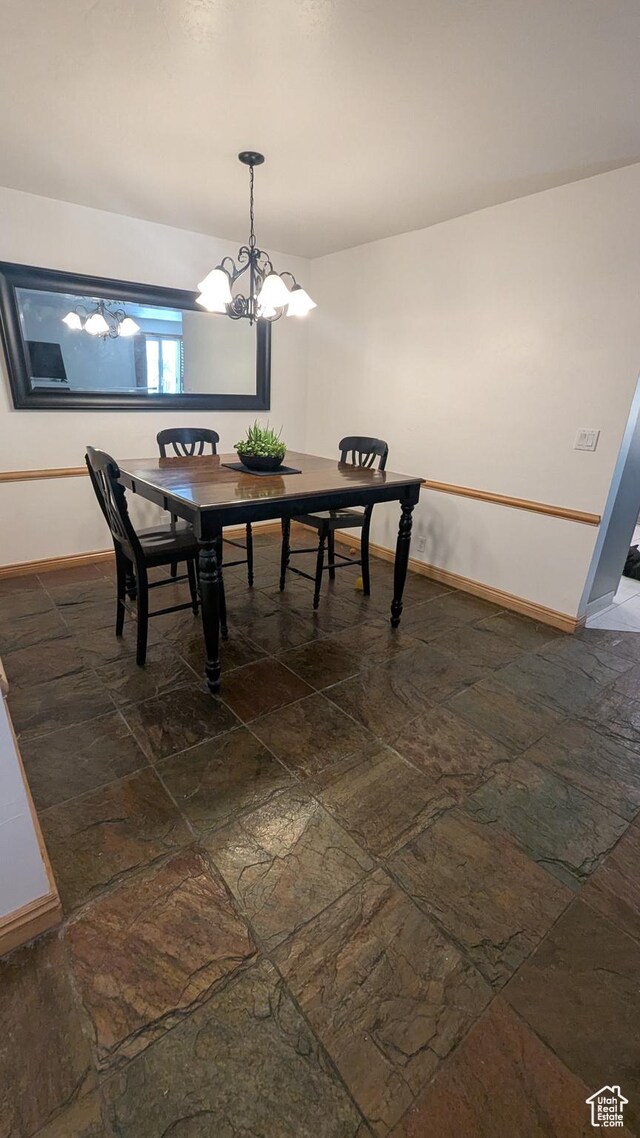 1584 E Petunia Way, Sandy, UT 84092 - dining room featuring a chandelier and dark stone finish floors