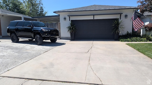 1584 E Petunia Way, Sandy, UT 84092 - view of home's exterior featuring brick siding, driveway, and an attached garage