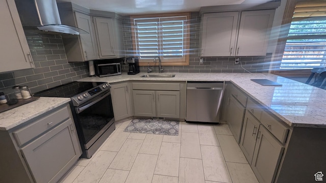 1584 E Petunia Way, Sandy, UT 84092 - kitchen with appliances with stainless steel finishes, gray cabinets, wall chimney range hood, and tasteful backsplash