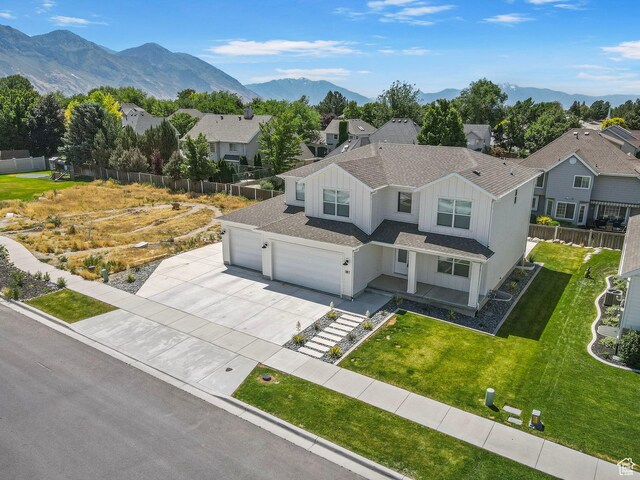 181 W 580 S, Orem, UT 84058 - view of front of home with board and batten siding, concrete driveway, a residential view, an attached garage, and a mountain view