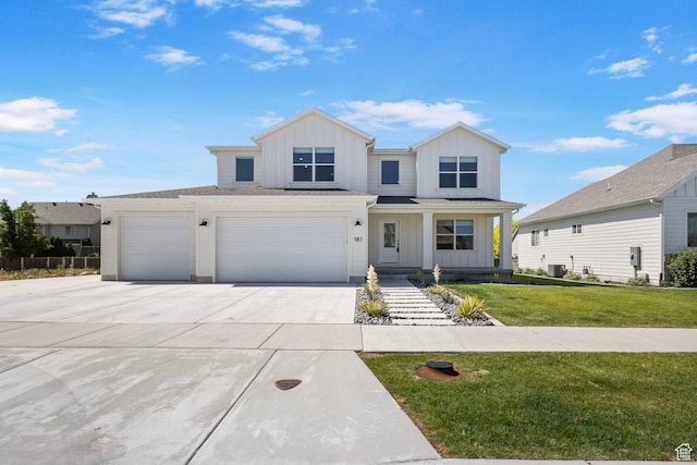 181 W 580 S, Orem, UT 84058 - view of front of house with board and batten siding, concrete driveway, a front lawn, and a garage