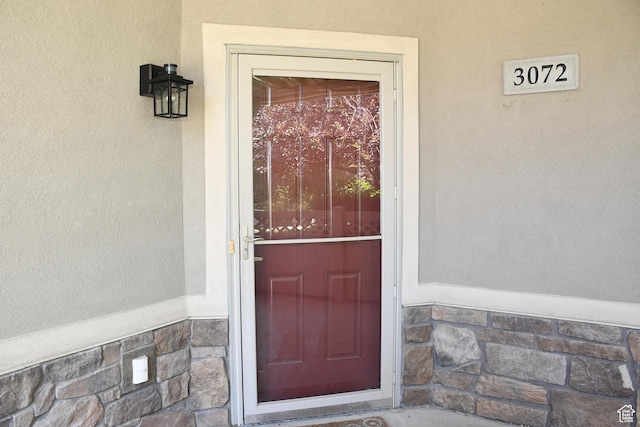 3072 W Leisure Villas Ct, West Jordan, UT 84084 - doorway to property with stucco siding and stone siding