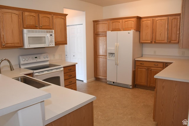 3072 W Leisure Villas Ct, West Jordan, UT 84084 - kitchen with white appliances, light floors, and brown cabinetry