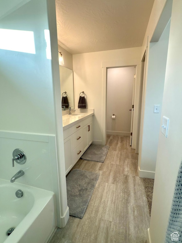 7494 N Silver Ridge Rd Unit 3466, Eagle Mountain, UT 84005 - full bathroom with wood finished floors, vanity, a garden tub, and a textured ceiling