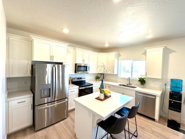 7494 N Silver Ridge Rd Unit 3466, Eagle Mountain, UT 84005 - kitchen featuring stainless steel appliances, light countertops, light wood-type flooring, a kitchen island, and recessed lighting