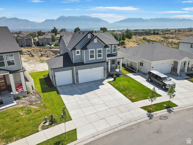 7494 N Silver Ridge Rd Unit 3466, Eagle Mountain, UT 84005 - traditional-style home with a mountain view, a residential view, a garage, concrete driveway, and a front yard