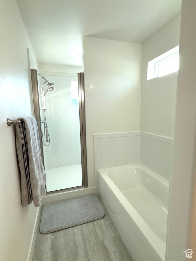 7494 N Silver Ridge Rd Unit 3466, Eagle Mountain, UT 84005 - full bathroom featuring wood finished floors, a garden tub, and a stall shower