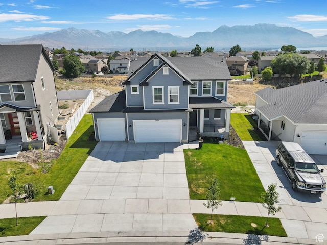 7494 N Silver Ridge Rd Unit 3466, Eagle Mountain, UT 84005 - traditional home with an attached garage, a residential view, driveway, and a mountain view