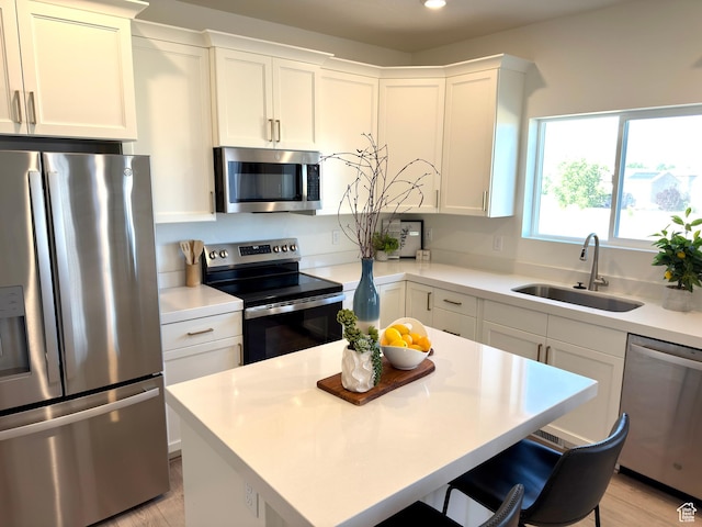 7494 N Silver Ridge Rd Unit 3466, Eagle Mountain, UT 84005 - kitchen featuring appliances with stainless steel finishes, a breakfast bar, white cabinetry, light countertops, and recessed lighting