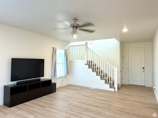 7494 N Silver Ridge Rd Unit 3466, Eagle Mountain, UT 84005 - unfurnished living room featuring ceiling fan, light wood finished floors, and stairs