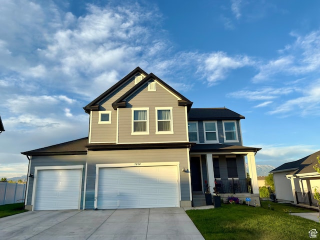 7494 N Silver Ridge Rd Unit 3466, Eagle Mountain, UT 84005 - view of front facade featuring driveway, a porch, and an attached garage