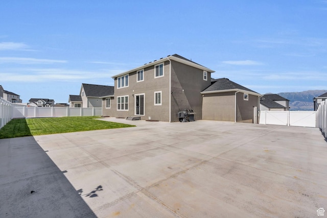 2873 S Puddle Ln, Saratoga Springs, UT 84045 - rear view of property featuring a gate, a fenced backyard, stucco siding, and a patio area
