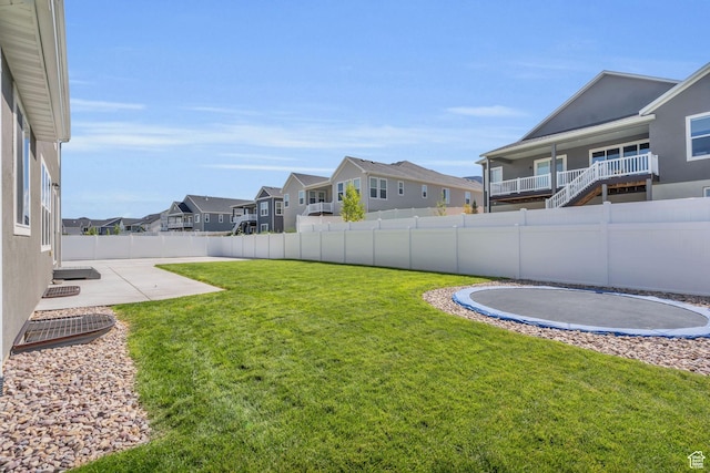 2873 S Puddle Ln, Saratoga Springs, UT 84045 - fenced backyard featuring a trampoline, a residential view, and a patio area